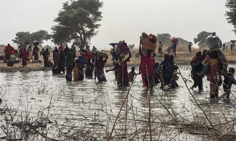 People who fled the Nigerian town of Rann after an attack by Boko Haram cross a river to seek shelter in Bodo, Cameroon