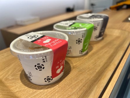 Three pots of natto on a wooden counter at a specialist store in Tokyo.
