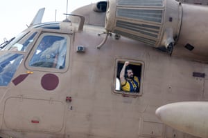 Ziv Berman, one of the Israeli hostages released by Hamas, gestures from the window of an Israeli helicopter