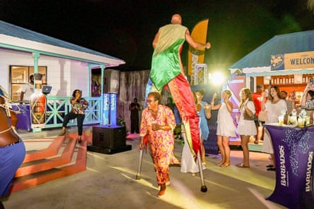 Andrea Franklin leads the conga line through the legs of the stilt-walker Troy Hunte.