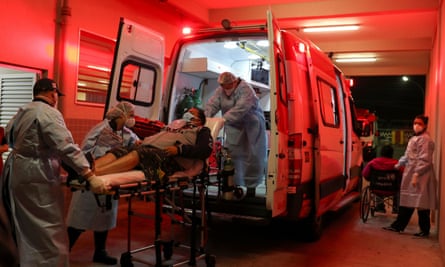 Members of an emergency mobile care service team take a couple from the ambulance to an emergency service unit to be treated for the symptoms of Covid-19 in São Paulo, Brazil, this week.