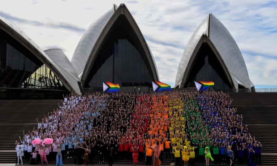 Participates dress in colours to create the LGBTQIA+ flag on the steps of the Sydney Opera House on Friday, 24 June 2022.