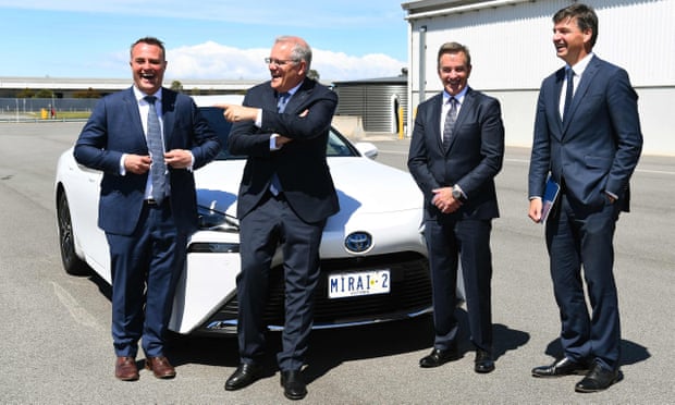 PM Scott Morrison, Angus Taylor, Tim Wilson and Toyota Australia president Matthew Callachor pose for a photo with a car
