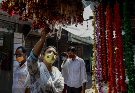 A woman looks for decorations at a roadside stall ahead of Diwali, in Kolkata, India. India’s confirmed coronavirus caseload surpassed 8 million on Thursday with daily infections dipping to the lowest level this week, as concerns grew over a major Hindu festival season and winter setting in.