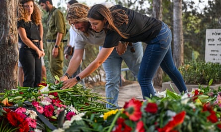 Raz and Tomer Itamari placing flowers on grave