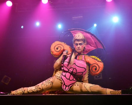 Peaches on stage in London in 2015, wearing an elaborate costume, with pink lighting behind her
