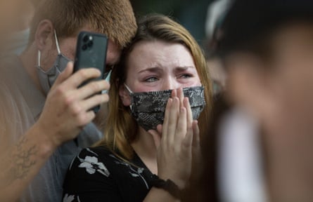 Chase Mayo comforts his wife, Anna Mayo, the sister of Garrett Foster, during a vigil in memory of Foster on 26 July 2020, in Austin, Texas.