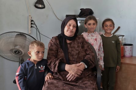 Souad al-Mukhamari with three children in her home in Sfai.
