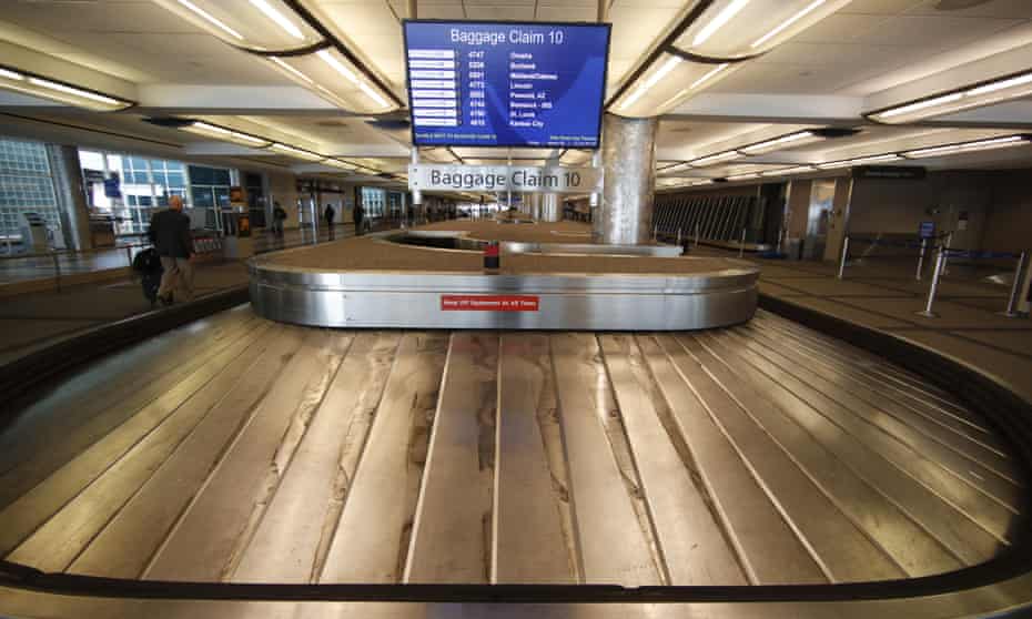 An empty baggage carousel spins in Denver International airport during the coronavirus pandemic.
