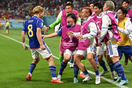 Ritsu Doan runs to celebrate with Japan substitutes.
