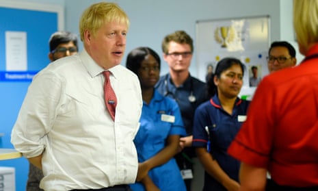 Boris Johnson speaks to medical staff during his visit to Watford general hospital in July