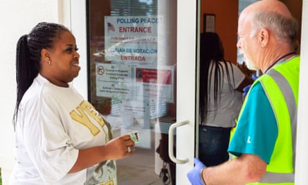 Wright speaking to a worker at a voting station