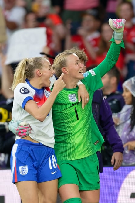 Chloe Kelly and Hannah Hampton with their arms around one another looking excitedly into the crowd