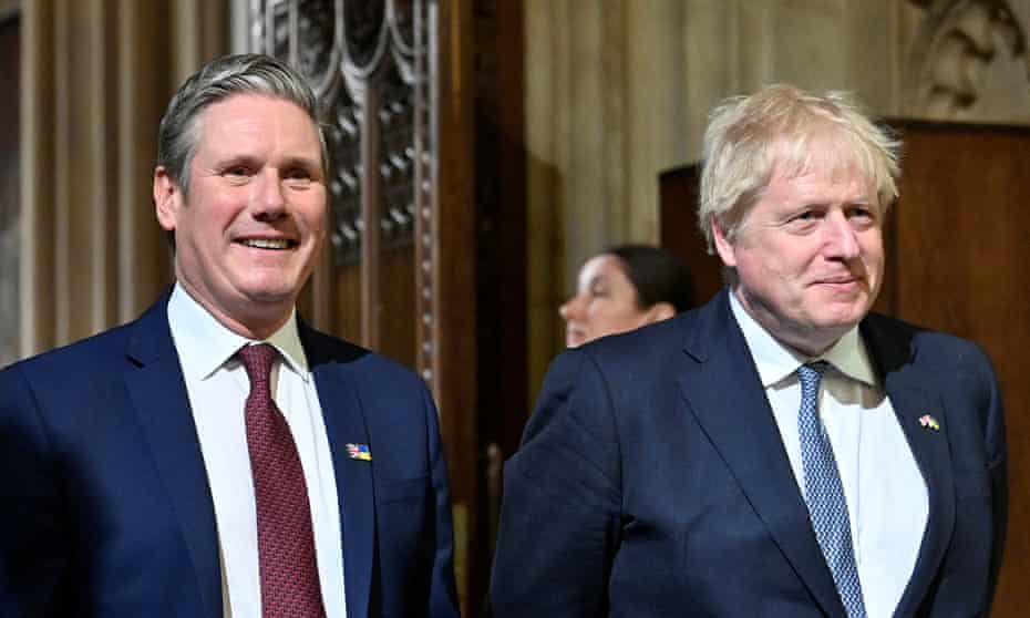 Keir Starmer and Boris Johnson walk through the central lobby at the Palace of Westminster, ahead of the state opening of parliament.