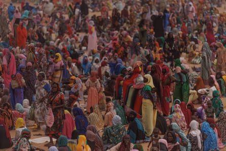 A large crown of people, mostly women and children