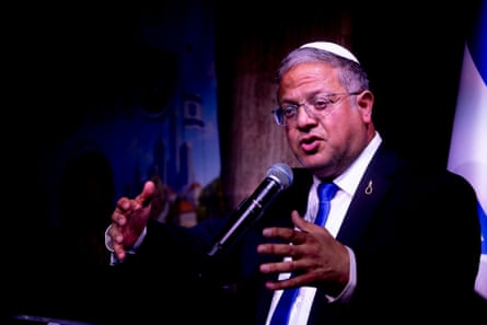 Itamar Ben-Gvir gestures with both hands as he speaks into a microphone
