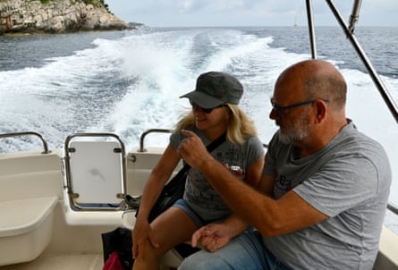 A man pointing something out to a woman on a boat