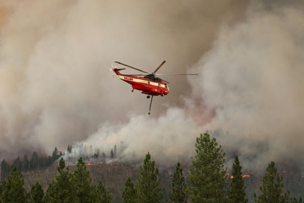 The US Forest Service performs a prescribed burn using incendiary balls dropped from a helicopter in Meadow Valley as a way to control the progress of the Dixie fire, on 31 July.
