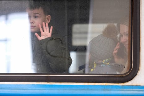 AcUkrainian boy says goodbye to his family as the train prepares to depart.