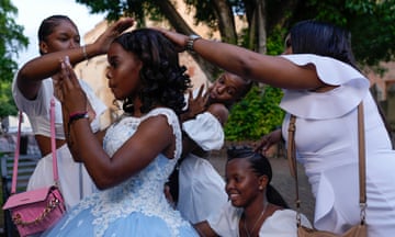 A quinceañera gets help getting ready for her party