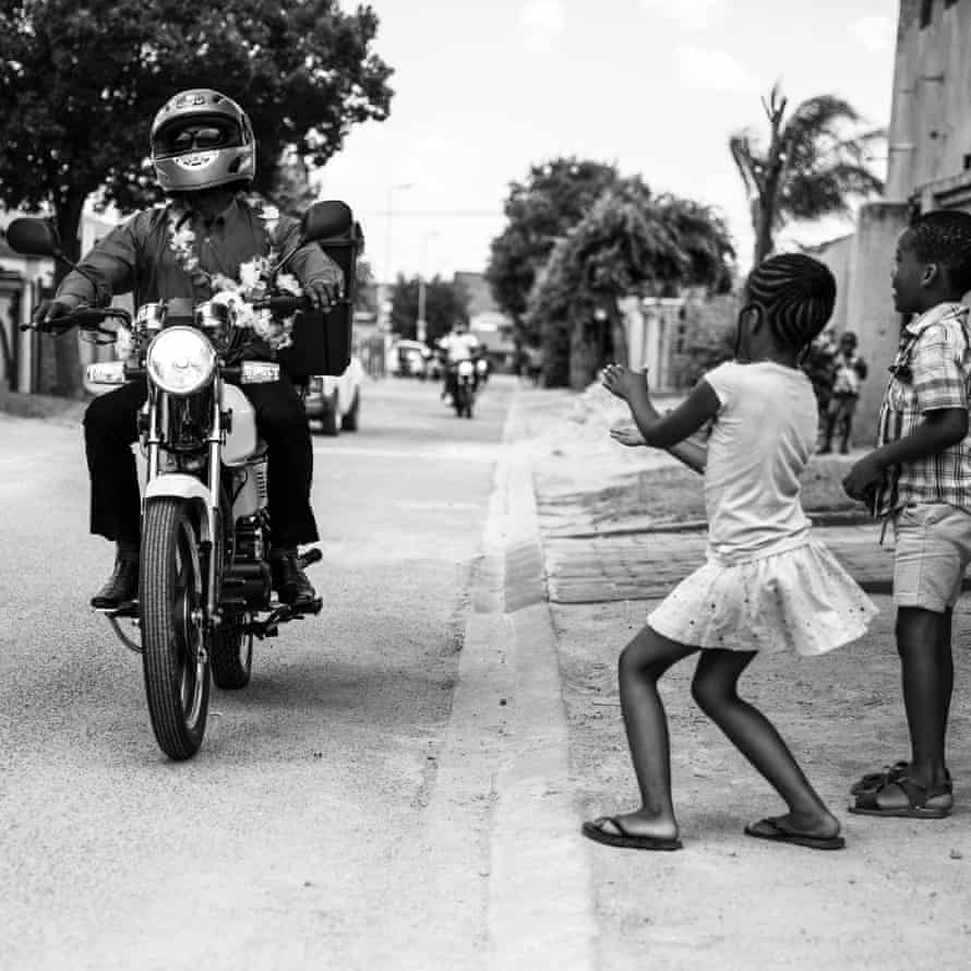 Ghost riders: the invisible lives of Johannesburg food couriers – photo essay | South Africa 25 Children cheer as the riders arrive at the wedding