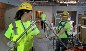 National Women in Construction Week<br>BOSTON, MA - MARCH 2: Alicia Miksic. apprentice electrician, bends an electrical pipe with electrician Adam DeFilippo at a work site at Brigham and Women's Hospital emergency department in Boston on March 2, 2020. This week, Skanska employees on construction sites all over Greater Boston are celebrating their female peers and colleagues on the job during national Women in Construction week. Skanska women in construction are welders, project managers, plumbers, carpenters, superintendents and everything in between, helping to build what matters in our communities while paving the way for future generations of female trades and construction workers in the industry. (Photo by David L. Ryan/The Boston Globe via Getty Images)
