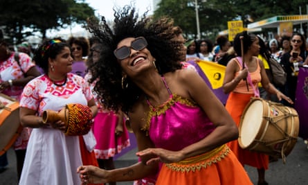 The Long Wave: Is Kemi Badenoch’s victory a win to Nigerians? A woman dances in the street during a musical protest march