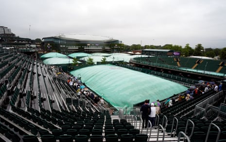 Courts are covered as rain pours down