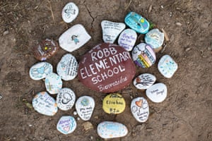 Uvalde, US. Painted stones at a memorial outside Robb elementary school in Texas the day after CCTV footage showing events during the shooting in May was released