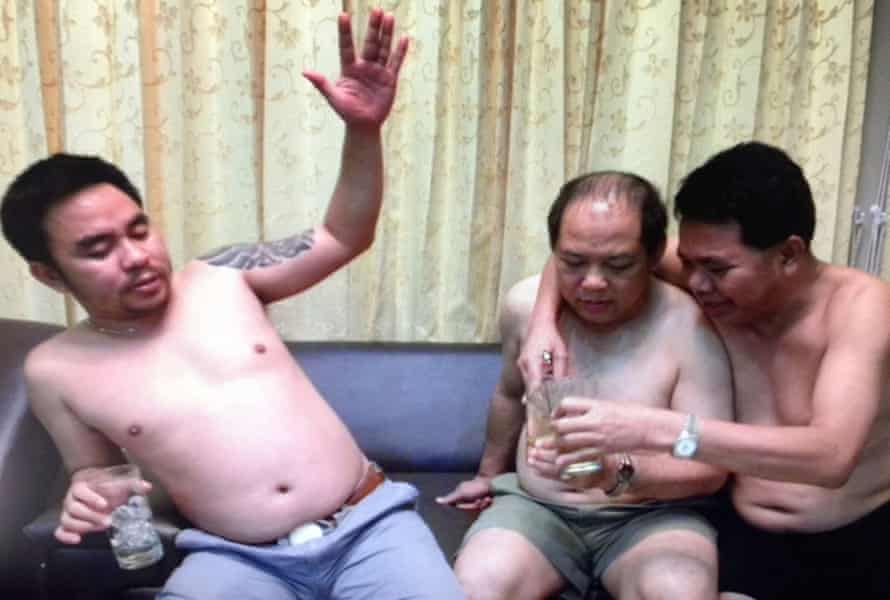Vixay Keosavang (centre) pictured shirtless and on holiday with the Bach brothers, ‘Boonchai’ and Van Limh