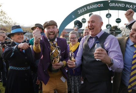 Thomas Kendall (with the trophy) and other owners of Corach Rambler celebrate after winning the Grand National during racing on day three of the Grand National jump racing festival at Aintree Racecourse.