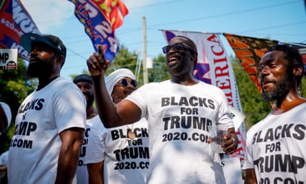 Blacks For Trump members gather on Rice Street to support the former president as he surrenders on racketeering charges in Atlanta on 24 August 2023.