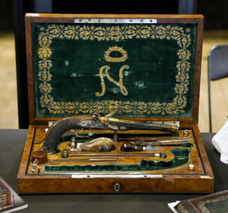 A staff member shows the box containing two pistols, which belonged to Emperor Napoleon I, during the preview before their auction, in Paris on 18 June 2024