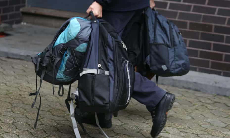 Bags are carried into an immigration centre in south London