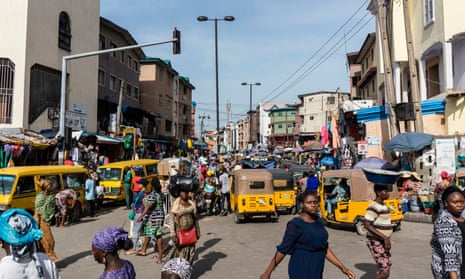 People walk through Balogun market in Lagos.