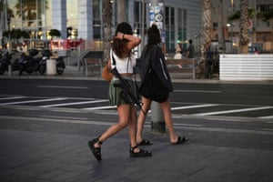 An off duty Israeli soldier carries an M16 assault rifle as she walks near Tel Aviv’s beachfront
