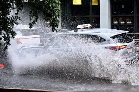 A car is seen driving along Turbot Street in the CBD as heavy rain hit Brisbane on Thursday.