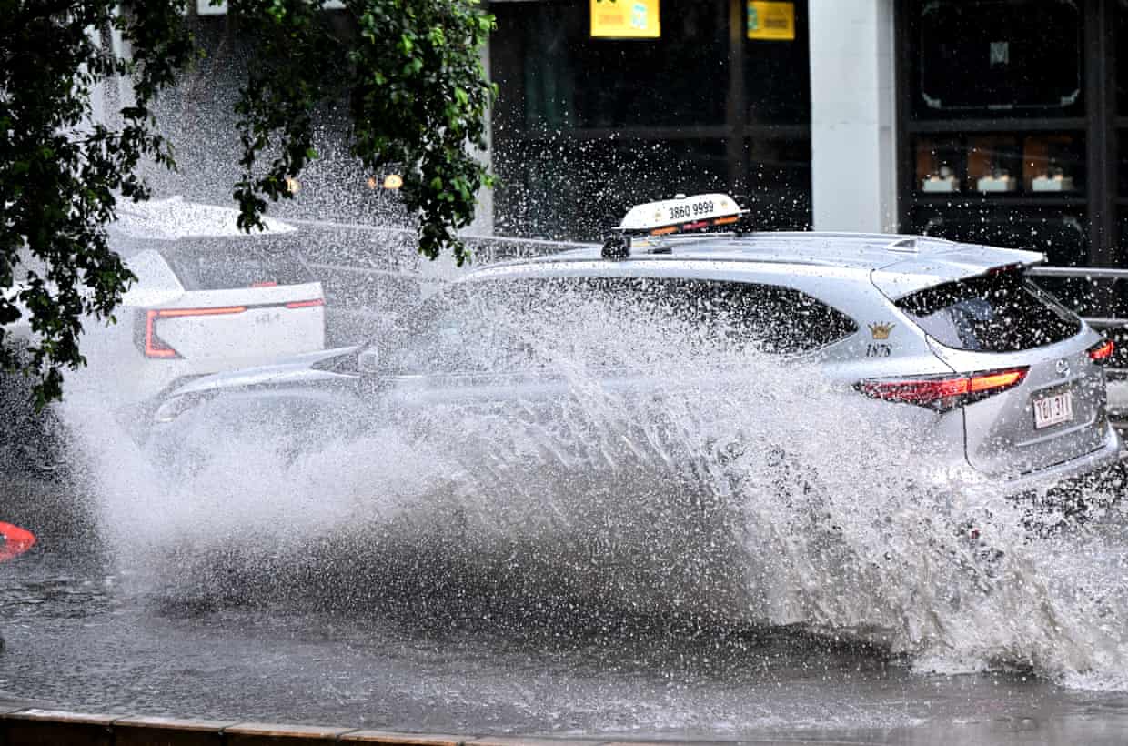 A car is seen driving along Turbot Street in the CBD as heavy rain hit Brisbane on Thursday.