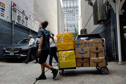 A worker delivers packages on Amazon Prime Day in New York, in July 2025.