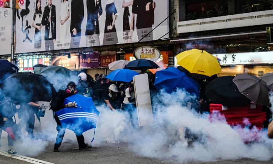 Riot police fire teargas at the protesters on Nathan Road during the demonstration in Hong Kong on Sunday.
