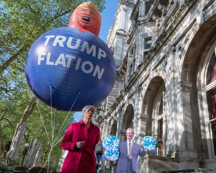 Daisy Cooper, the deputy leader of the Lib Dems, in Westminster with an inflatable caricature of Donald Trump and the words ‘Trumpflation’
