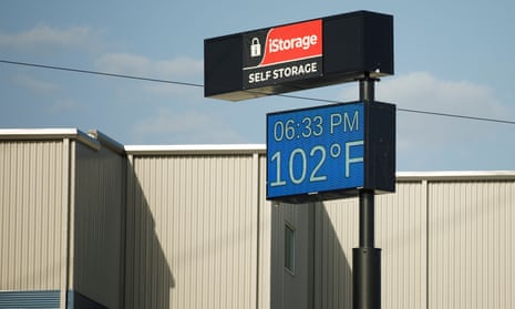 A sign reads the temperature at 102F in San Antonio, Texas, on Monday