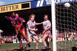 Andy Gray beats Steve Staunton and Whelan to head Palace’s third goal.