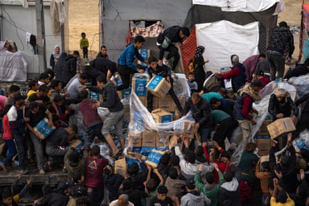 Desperate Palestinians loot a humanitarian aid truck as it crossed into the Gaza Strip.