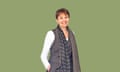 Caroline Lucas wearing a brown patterned scarf, waistcoat and trousers over a long-sleeve white T-shirt