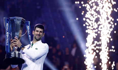 Novak Djokovic holds the Nitto ATP Finals trophy.