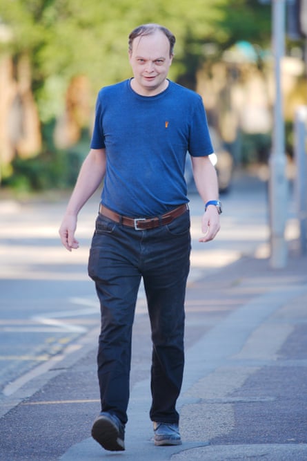 Philip Jerome, in T-shirt and jeans, smiling and walking towards the camera