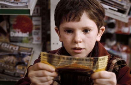 Freddie Highmore as Charlie Bucket with the winning ticket in the 2005 film Charlie and the Chocolate Factory. Photograph: Peter Mountain/Warner Bros/Reuters