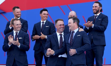 Justin Thomas embraces the US captain Zach Johnson during the opening ceremony.