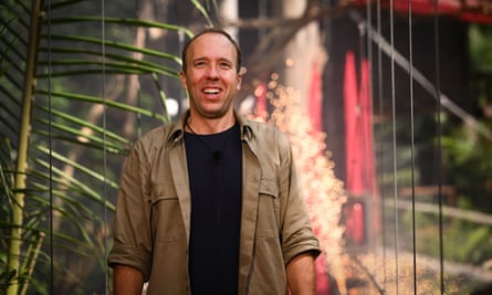 Matt Hancock seen in Australia during I’m A Celebrity … filming: he wears a khaki shirt with rolled-up sleeves and a black T-shirt and is standing in a forest